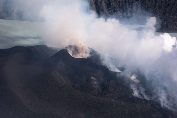Large volumes of stone and cooling lava can be seen spewing non-stop from two new vents in the volcano on top of Ambae's mount Lombenben.
