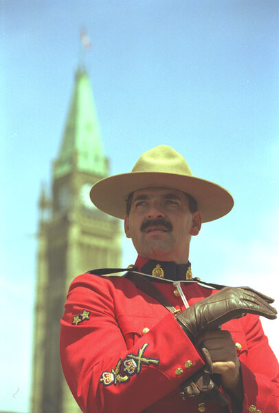 This is my compulsory 'Don't you Love a man in uniform?' shot. Taken
on Canada Day, 1999, this shot just goes to show that sometimes the
stereotypes are true. This man was dashing, kind and gallant toward 
everybody he met that day.
