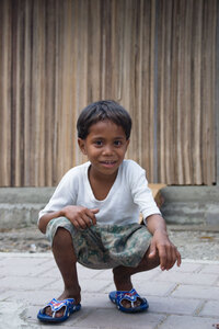 I tried to take a low-angle shot of a roadside shopkeeper's son, but he followed me down. Oh well, cute shot nonetheless.
