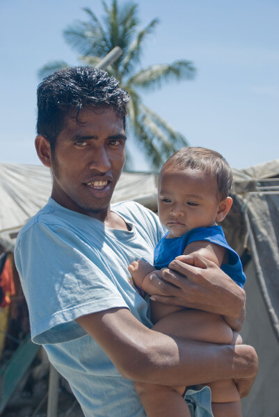 A scene from the camp for Internally Displaced Persons in Dili. Over 40,000 people still occupy camps like this. This young man, named August, took it on himself to give me a tour of the entire camp. He's pictured here with his infant son.
