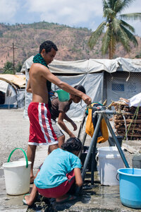 A scene from the camp for Internally Displaced Persons in Dili. Over 40,000 people still occupy camps like this. These six stand pipes represent the entire camp's water supply.
