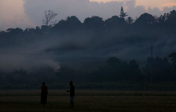 Smoke drifts over the nearby hills as the sun sets on the Freswota neighbourhood in Port Vila.
