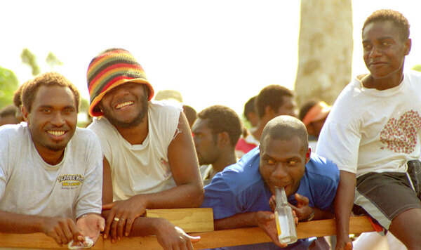 
Kiwanis Race day is a huge event in Port Vila. Nearly a third of the
population gathers on the Elluk heights overlooking Port Vila harbour
to watch the finest horses in the nation show their mettle. 
I was walking along the inner ring of the track when these four men
shouted out at me to take their photo.

