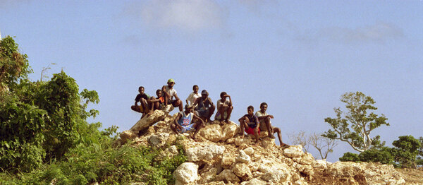 
Kiwanis Race day is a huge event in Port Vila. Nearly a third of the
population gathers on the Elluk heights overlooking Port Vila harbour
to watch the finest horses in the nation show their mettle. 
People went to some lengths to get a decent vantage. This group walked 
in from the other side of the quarry and parked themselves at its rim.

