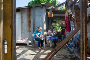 Wilma nurses her baby, Francois, in the middle of their family home on Ifira island. It is still in need of major renovations three months after cyclone Pam caused extensive damage.
