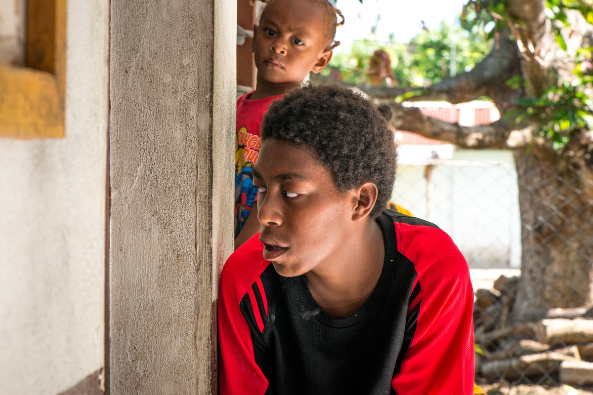 A boy peeks into the door of the community clinic on Ifira island, as he waits for his younger brother, who was experiencing respiratory problems.
