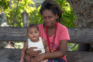 A young woman holds her friend's baby, just 5 months old, on Ifira island. Thanks to timely measures, children's health in Vanuatu has not suffered significantly in the months since cyclone Pam.

