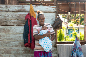 Wilma Kaltiriki and her newborn son, Francois, at home on Ifira island. Their house has yet to be fully repaired after it was badly damaged by cyclone Pam.
