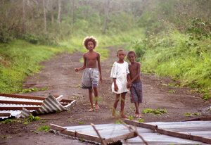 
Children from the town stroll through the wreckage. This roof was tossed
about 20 metres by the wind.

