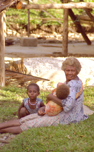 A grandmother tends her grandchildren. The mother was most 
likely working in the gardens on the nearby mountainside.

