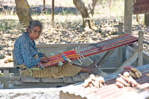 A woman at work at her loom. The traditional fabrics in Timor-Leste are fascinatingly complex in design.
