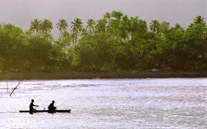 Two young men head out into Sola Bay as the sun sets behind them.
Tonight, they'll hunt for lobster and reef fish.
