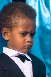 The wedding ceremony can't finish nearly soon enough
for this young boy.
