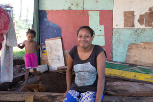 Rachel's mother Melissa sits in a half-finished house built from salvaged materials.

