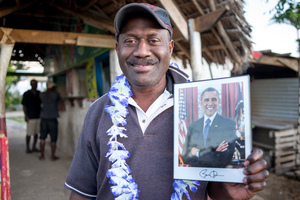 Didier proudly shows his new autographed portrait of US President Barack Obama.
