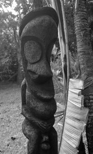 A black palm carving typical of the traditional Ambrym island style. Yes, the figure is doing what you think it's doing. 
