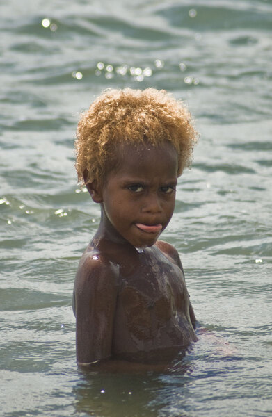 A young tannese boy swims at Backsand Beach in Port Vila.
