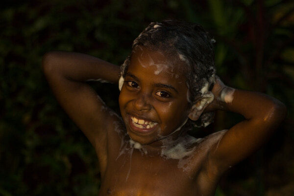 Sundown is 'swim' (i.e. wash-up) time for children throughout
Vanuatu. It's usually conducted under a hose or with a bucket
out in the main yard.
