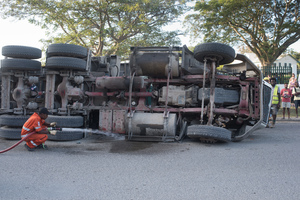 Fire services disperse spilled fuel after a container carrier overturned at the USP roundabout. Traffic was snarled in all directions.
