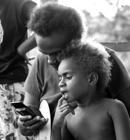 A mother shows her daughter how to text