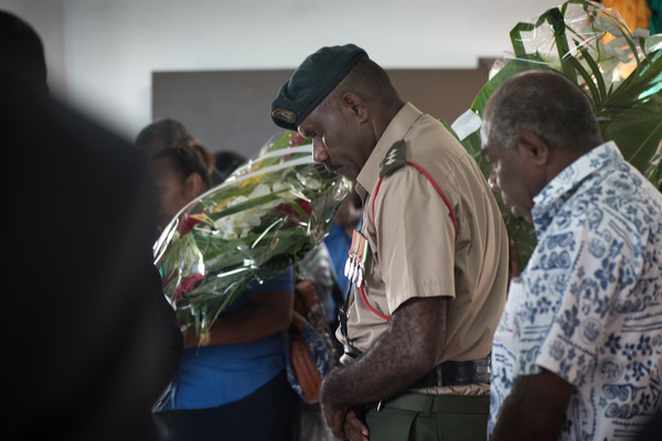 An officer of the Vanuatu Mobile Force bows his head as he pays his respects to  President Baldwin Lonsdale, whose body lies in state.
