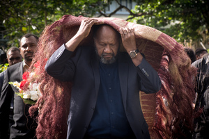 Prime Minister Charlot Salwai covers himself with a ceremonial red mat as he pays his respects to President Baldwin Lonsdale, whose body lies in state at the State House Nakamal.
