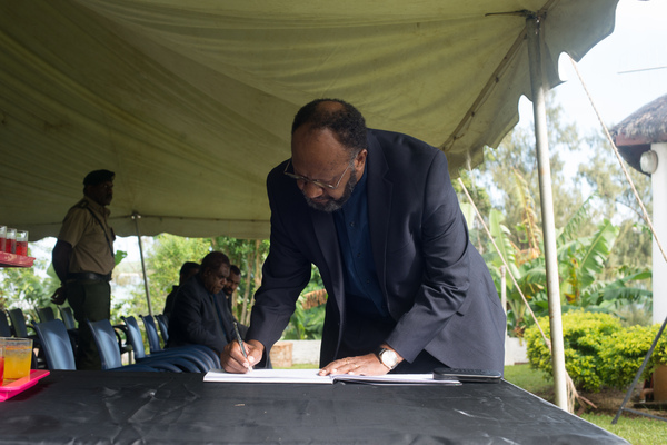 Prime Minister Charlot Salwai signs the condolence book as President Baldwin Lonsdale lies in state.
