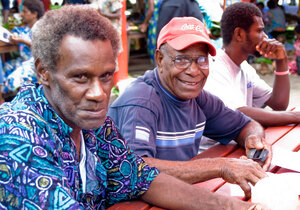 Taken at a Digicel event in Port Vila's market building. Digicel staff demonstrated their new GPRS service to interested people. For these two men from North Efate, it's probably their first exposure to the Internet.
