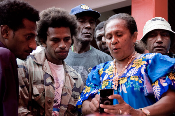 Digicel's Maureen George demonstrates their new GPRS mobile Internet service to interested onlookers.
