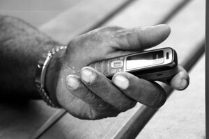 This hand is more accustomed to holding a bush knife than an Internet-connected mobile phone.