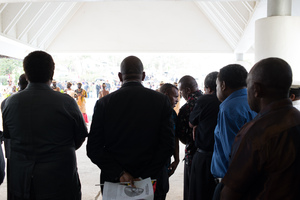 Throngs of people line up in the rain to pay their respects to Edward Natapei, whose body lies in state at Parliament.
