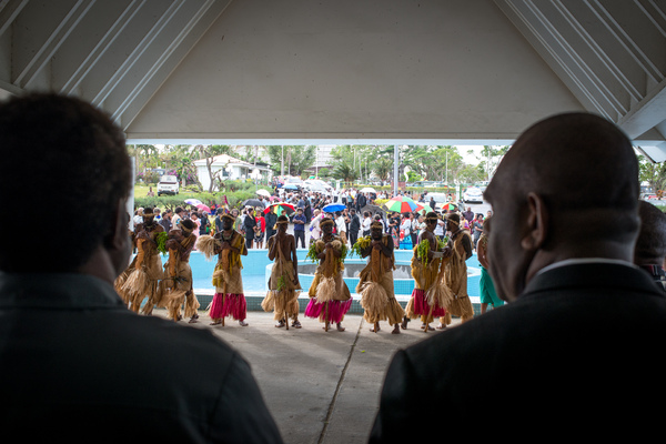 Throngs of people line up in the rain to pay their respects to Edward Natapei, whose body lies in state at Parliament.
