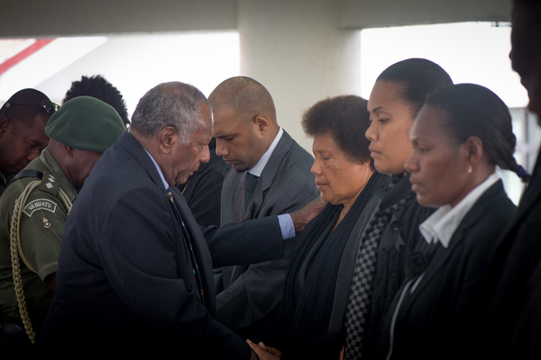 President Baldwin Lonsdale comforts the wife of Edward Natapei.
