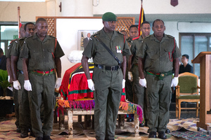 An honour guard stands at attention over the body of President Baldwin Lonsdale.
