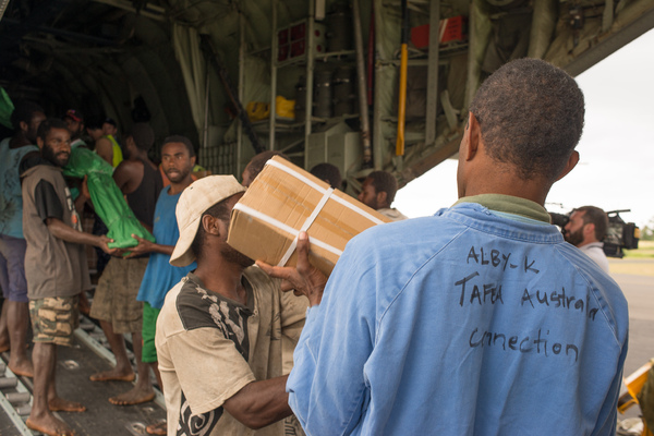 Australian governor general Peter Cosgrove's visit to Tanna underlines how much work remains to be done in the aftermath of cyclone Pam. Tannese men offload bush knives and other essentials from an RAAF relief flight.
