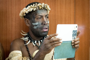 Old meets new: A Futunese Kastom Dancer records a speech by prime minister Charlot Salwai on on tablet during the opening ceremony of ICT Days in Port Vila.
