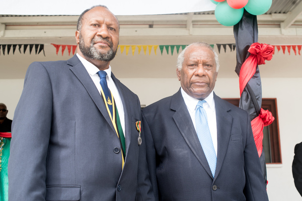 Prime Minister Charlot Salwai receives a distinguished service medal from President Baldwin Lonsdale.
