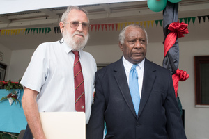 Emeritus Professor John Lynch receives a distinguished service medal from President Baldwin Lonsdale.
