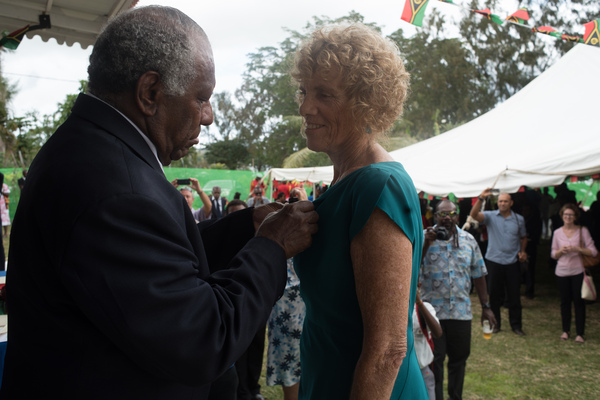 The principal of the Port Vila Internatonal School receives receives a meritorious service medal from President Baldwin Lonsdale.
