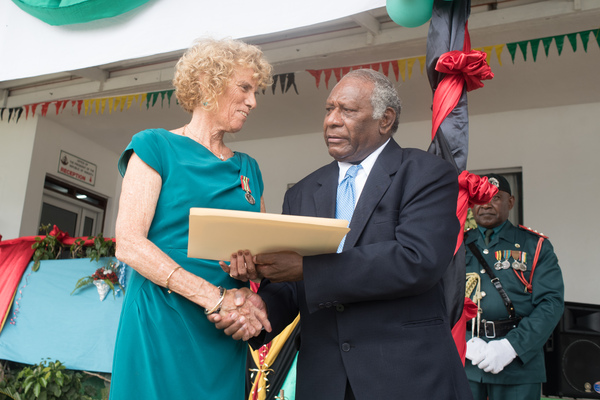 The principal of the Port Vila Internatonal School receives receives a meritorious service medal from President Baldwin Lonsdale.
