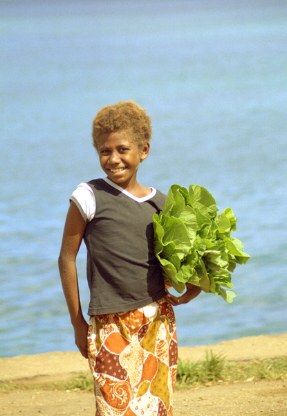 A young girl carrying local lettuce waits for the 
next boat to nearby Ifira island.


