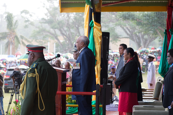 Prime Minister of Vanuatu Sato Kilman reviews the troops as rain falls on Vanuatu's 35 independence day celebrations.
