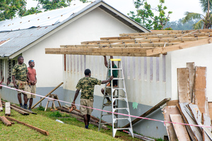 Members of the Engineering company of the Vanuatu Mobile Force rebuild a classroom that had been badly damaged by cyclone Pam. Without the assistance of UNICEF and other agencies, the school would have been forced to close, leaving the education of hundreds of students in doubt.
