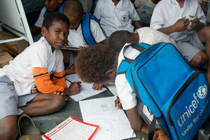 Students from Vila North school in Port Vila work inside the tent that has been their classroom since cyclone Pam destroyed part of the school. UNICEF's extensive support has made it possible for Vila North to continue providing an education for hundreds of children.
