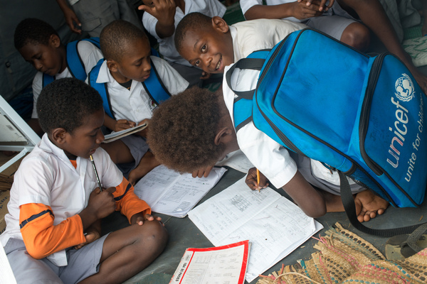 Students from Vila North school in Port Vila work inside the tent that has been their classroom since cyclone Pam destroyed part of the school. UNICEF's extensive support has made it possible for Vila North to continue providing an education for hundreds of children.
