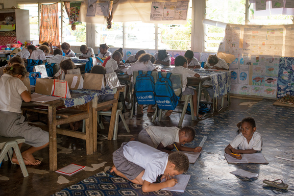 Students from Vila North school in Port Vila work using materials provided by UNICEF, whose extensive support has made it possible for Vila North to continue providing an education for hundreds of children.
