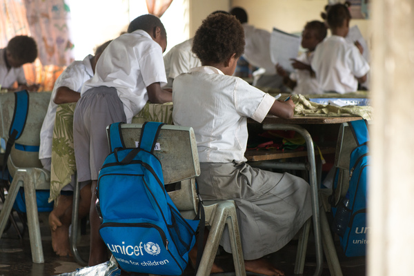 Students from Vila North school in Port Vila work using materials provided by UNICEF, whose extensive support has made it possible for Vila North to continue providing an education for hundreds of children.
