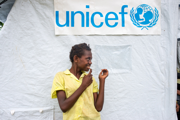 Ellen, a 13 year old student from St Joseph school near Port Vila stands outside the tent that has been her classroom since cyclone Pam destroyed part of the school. If not for the shelter supplied by UNICEF, students would have been sent home on a rotating basis.
