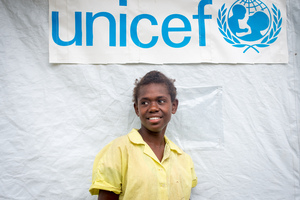 Ellen, a 13 year old student from St Joseph school near Port Vila stands outside the tent that has been her classroom since cyclone Pam destroyed part of the school. If not for the shelter supplied by UNICEF, students would have been sent home on a rotating basis.
