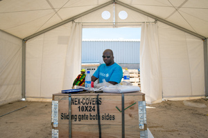 Staff and volunteers wrangle over 90 tonnes of newly arrived emergency supplies at the UNICEF warehouse near Port Vila, Vanuatu. The influx of supplies required the construction of a new temporary storage facility as well.
